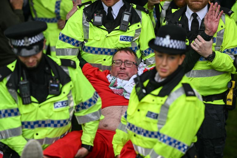Police officers arrest a protester during a demonstration in support of the proscribed group Palestine Action outside the conference venue on the first day of the annual Labour Party conference in Liverpool, north-west England, on September 27, 2026 [Oli Scarff/AFP]