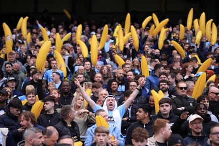 Manchester City fans hold up inflatable bananas