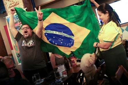 Supporters of Flávio Bolsonaro react after the country’s electoral authority announced the runoff.