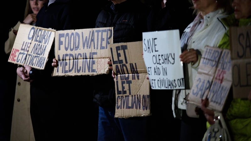 Activists hold placards with slogans during a rally in support of residents of Oleshky, Kherson region