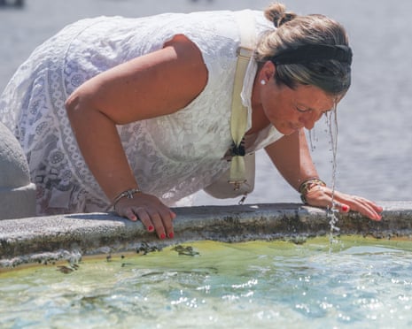 A woman after dunking her head in a fountain.